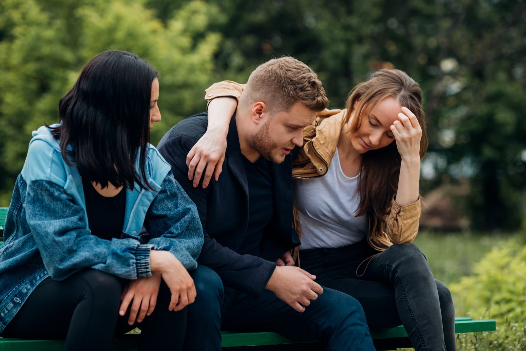 A person coping with job loss talking to their friends for support.