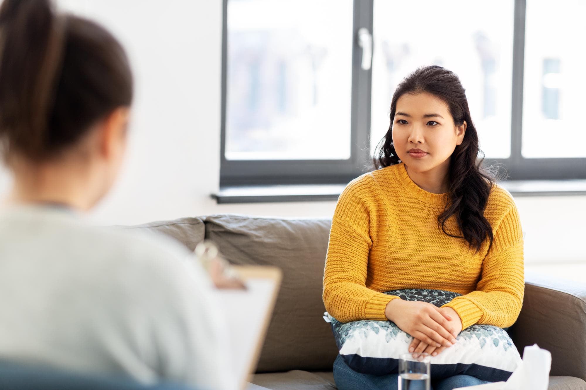 A young Singaporean woman engages in therapy for women's mental health.