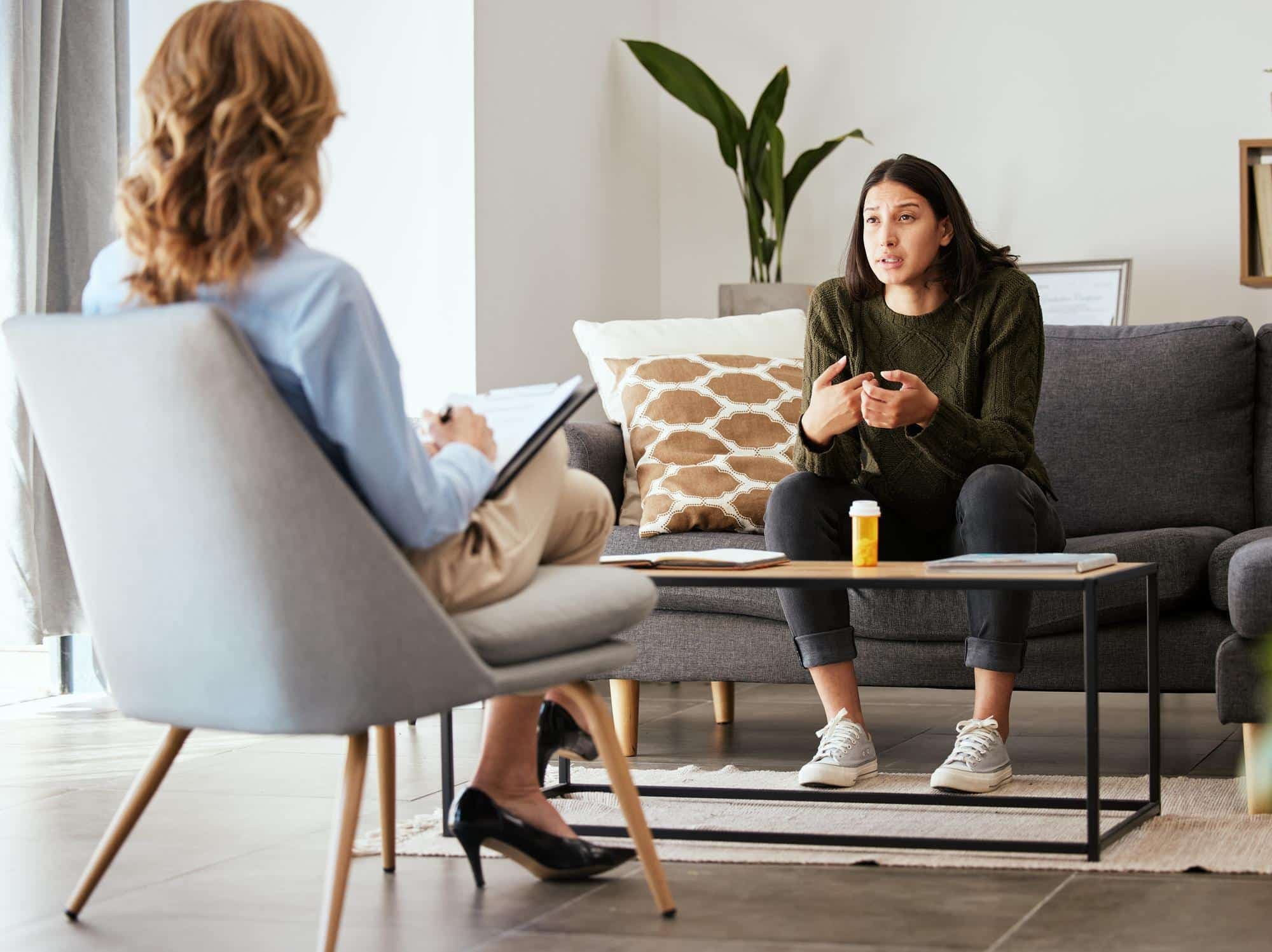 A person engaging in therapy provided through their company's EAP in order to navigate stress management at work.