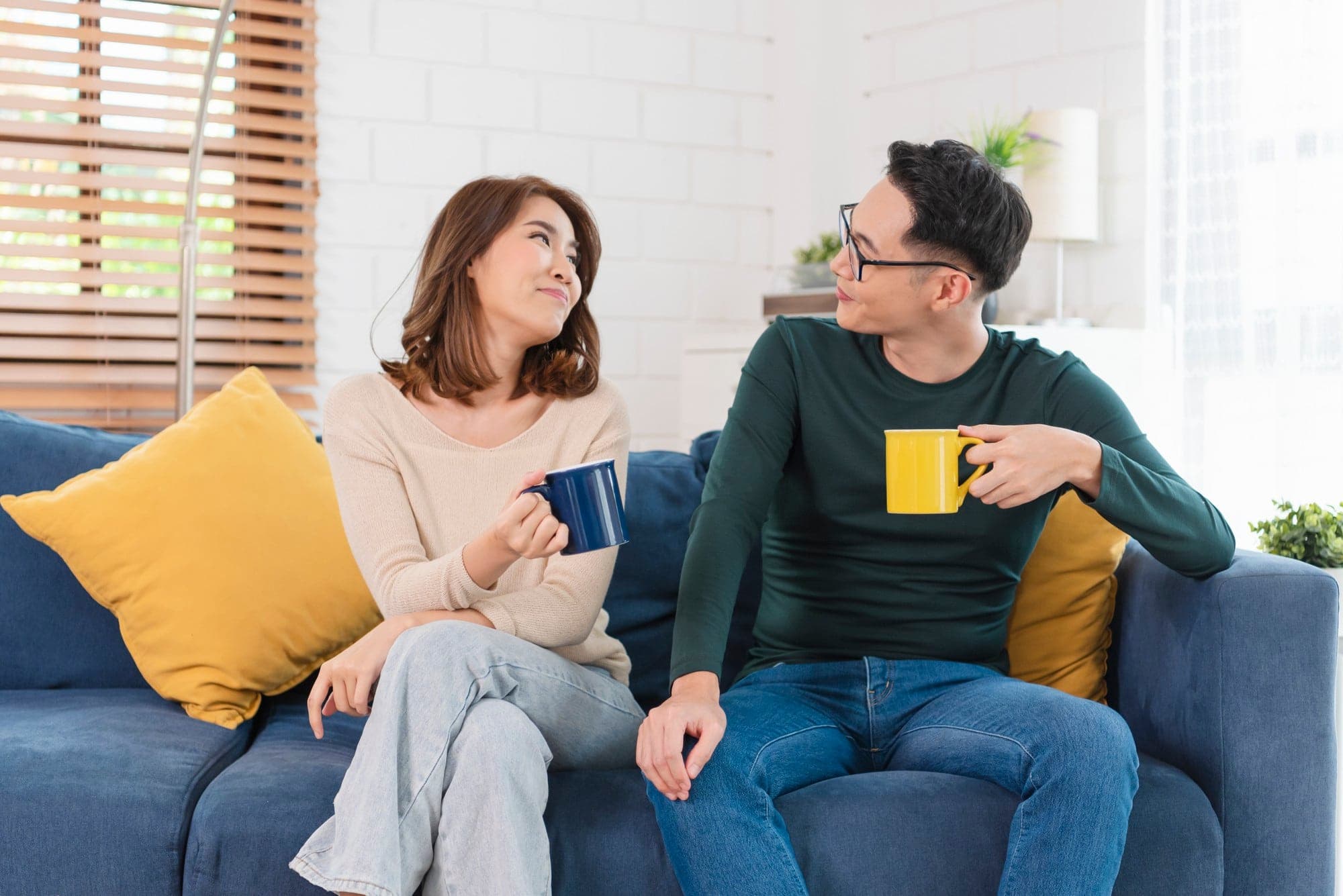 A Singaporean couple reflecting on a relationship conflict together.