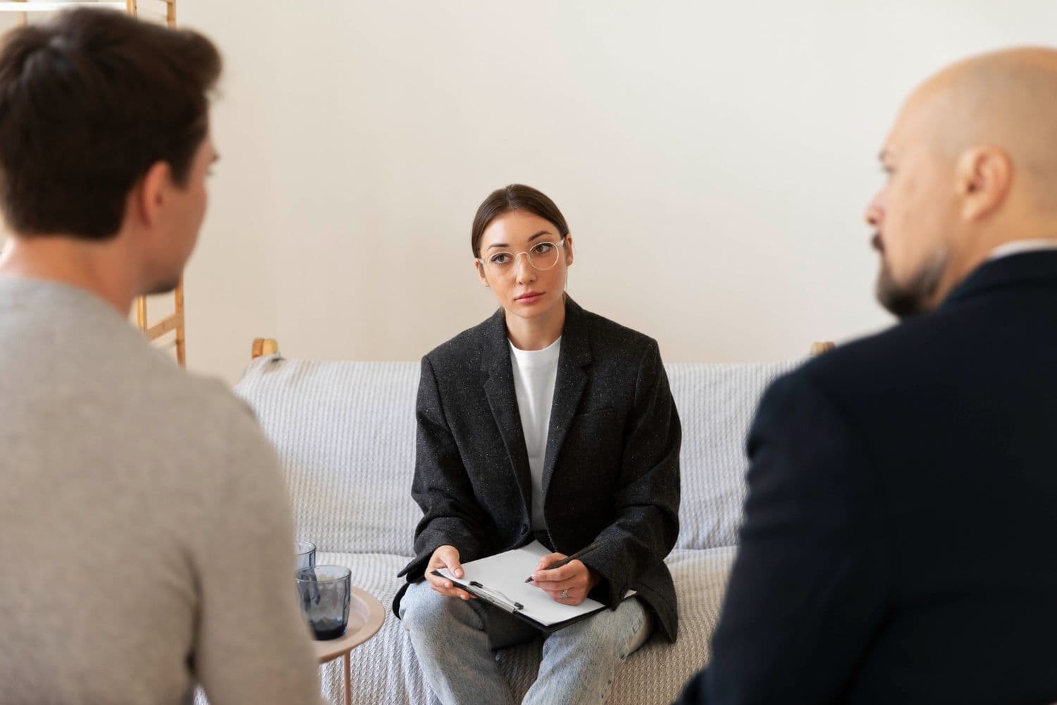 A couple talking to a divorce counsellor in Singapore during divorce support therapy.