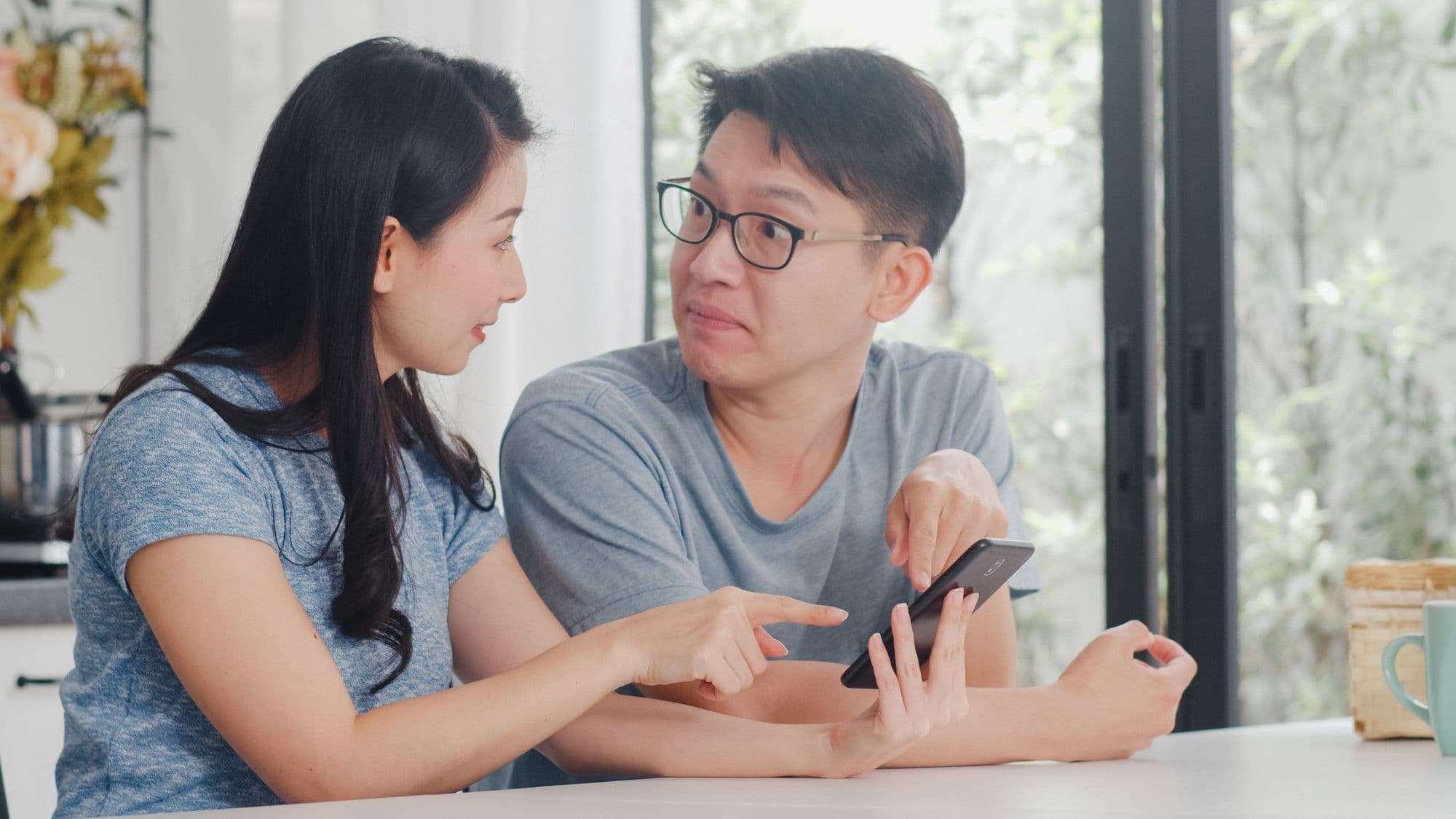 A couple discussing different topics they want to explore during premarital counselling in Singapore.