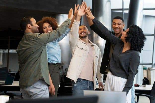 A team of corporate employees sharing a moment of bonding and connection after an employee assistance program seminar.