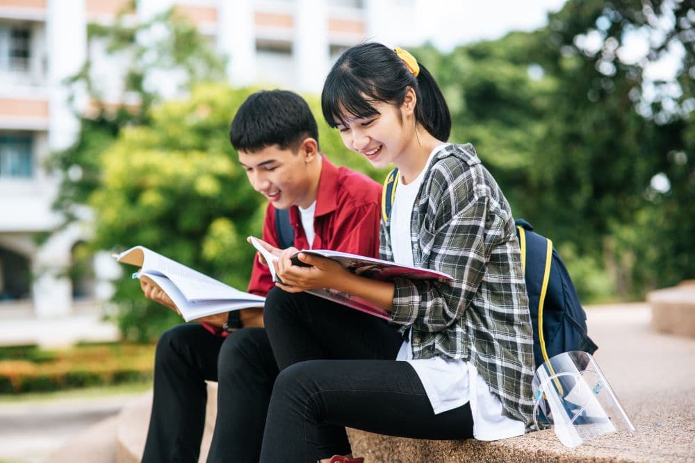 Two Singaporean students looking happy after engaging in online therapy for students.